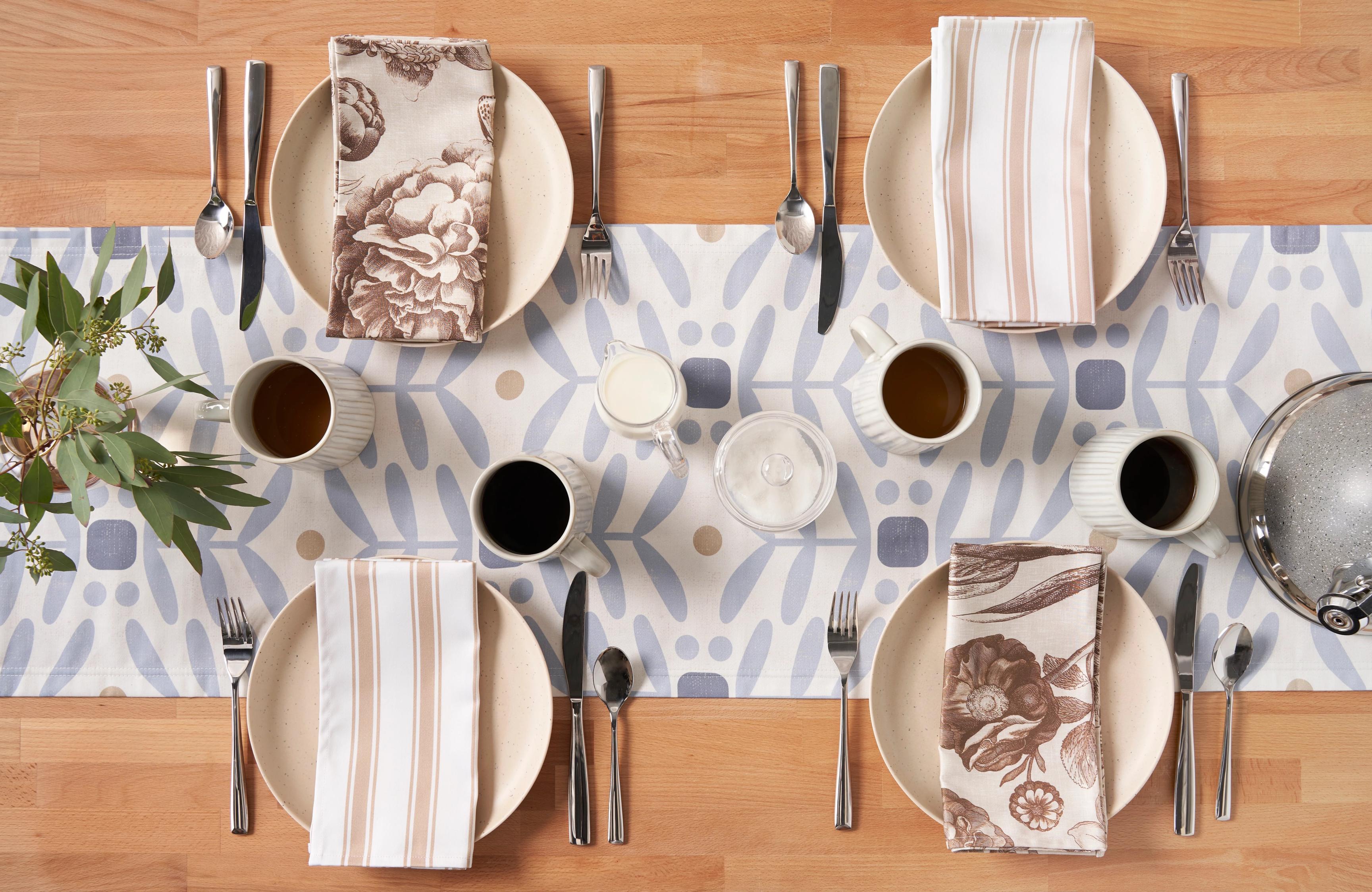 Two sets of dinner napkins on a set table