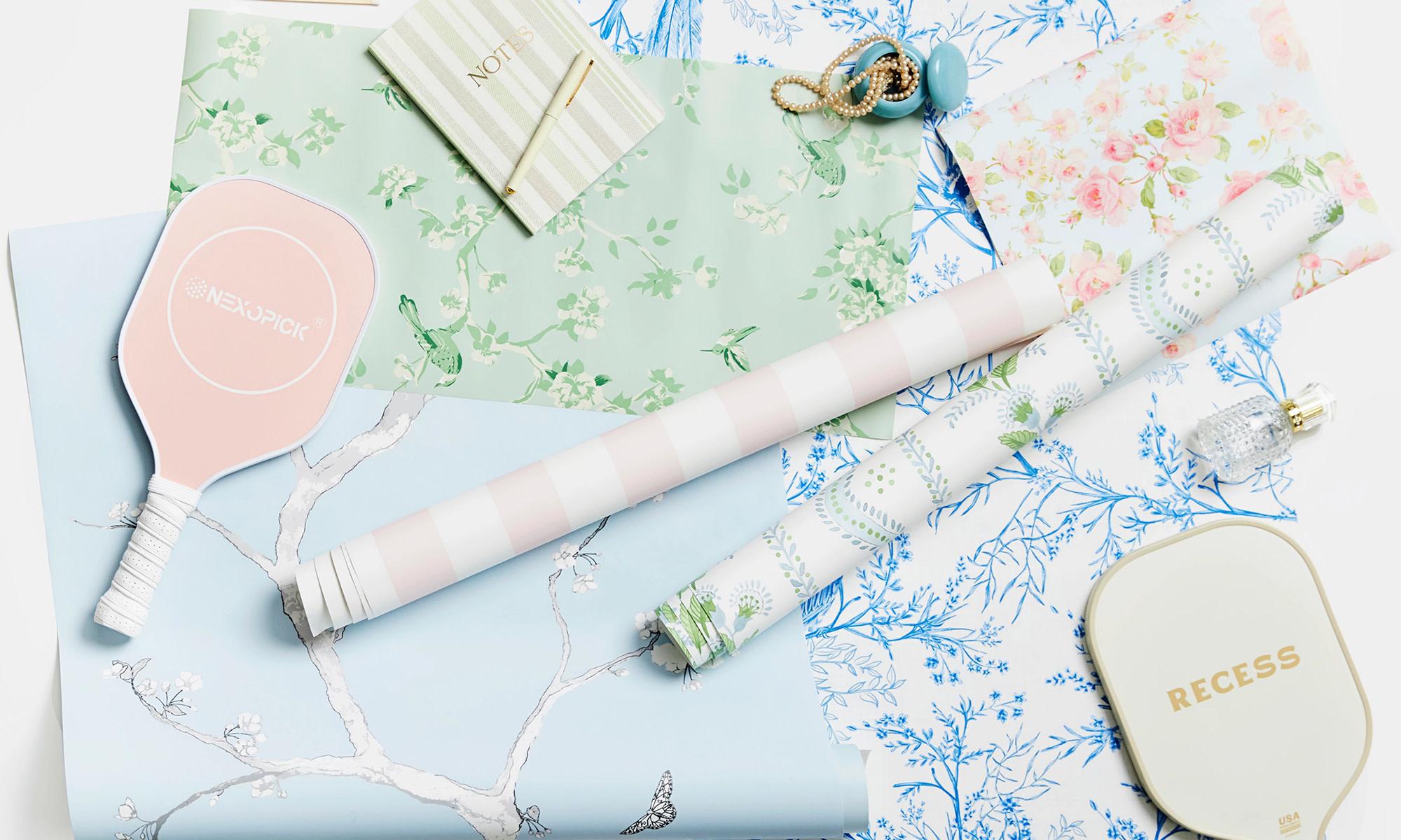 Preppy green, pink and blue wallpaper swatches styled together.