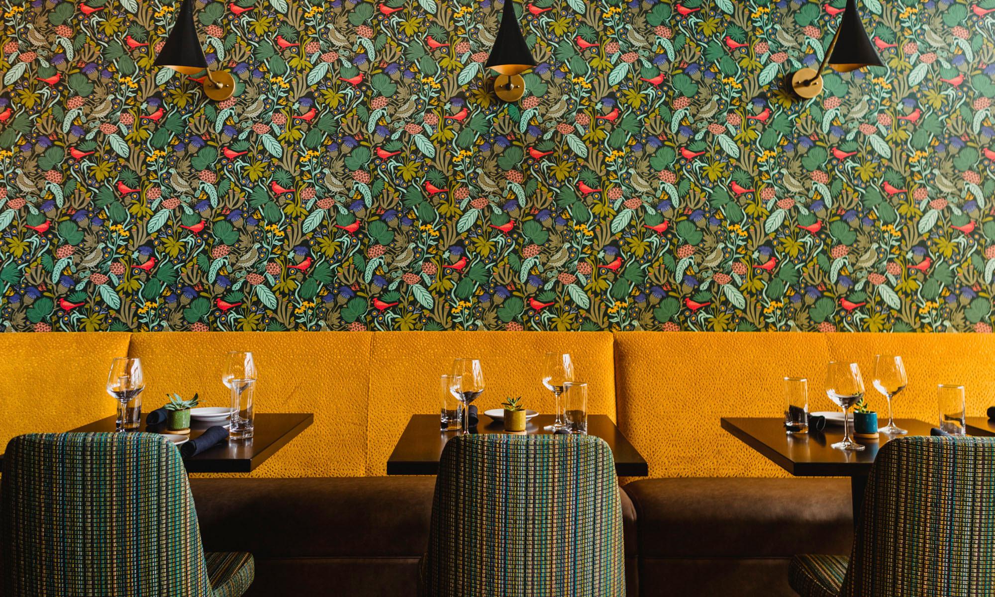 The Mayton Hotel's restaurant with floral wallpaper.