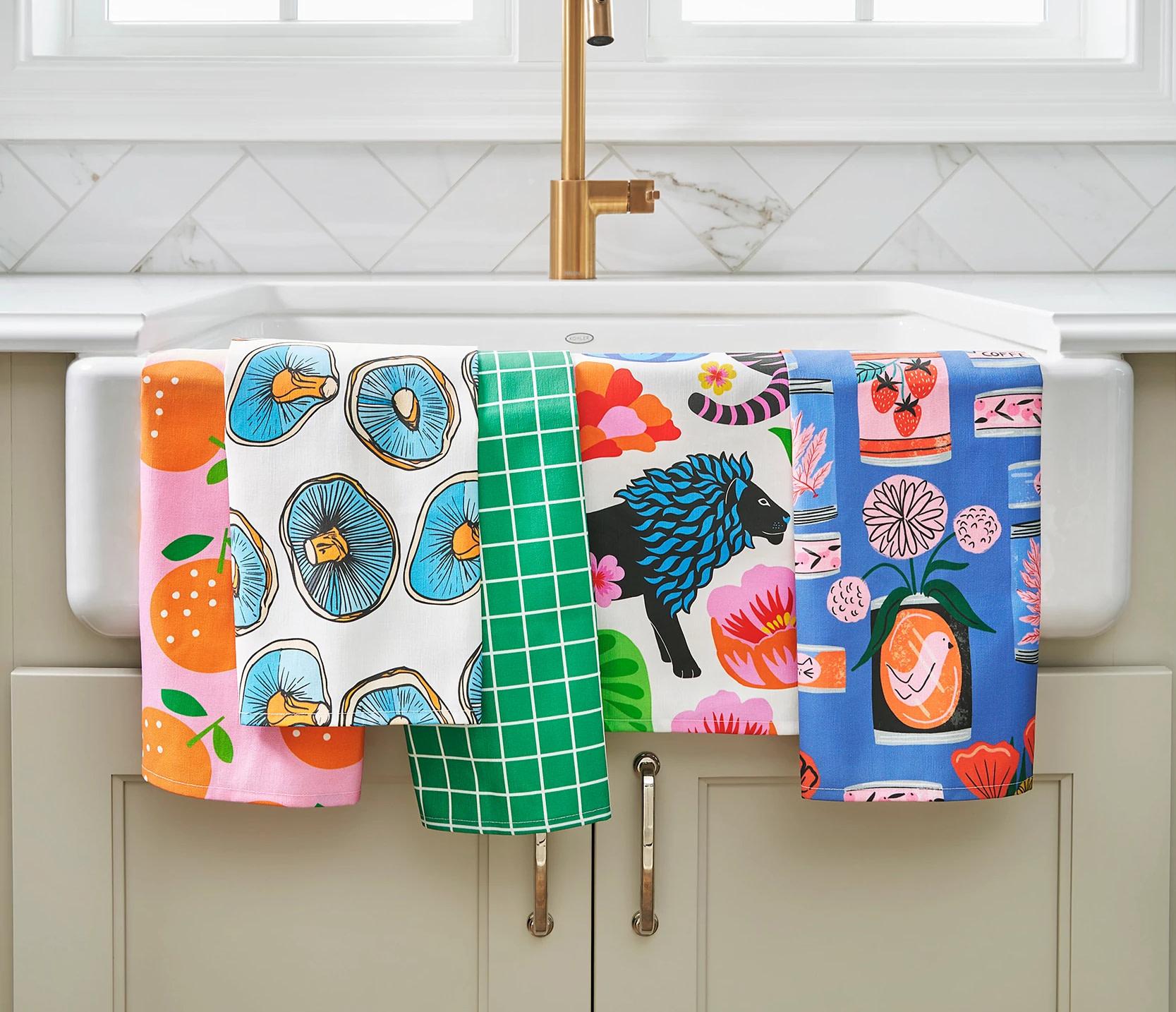 Colorful tea towels draped over a sink