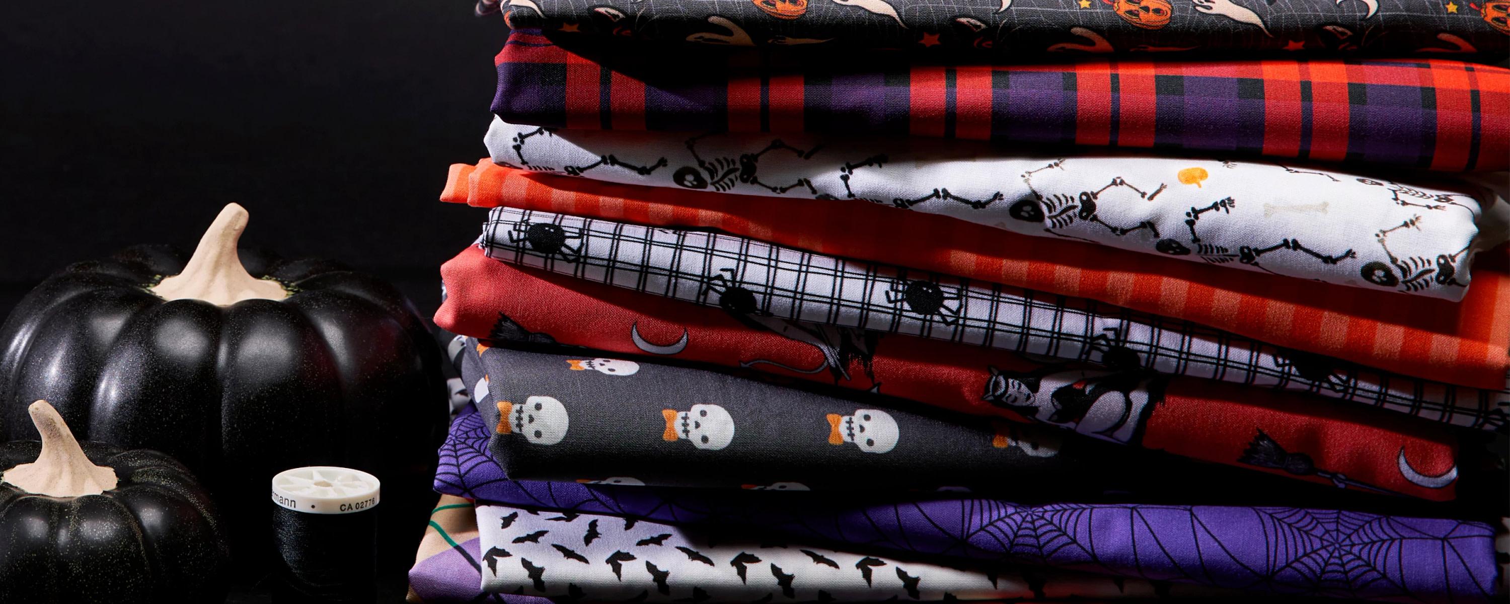 Stack of classic halloween design fabrics.