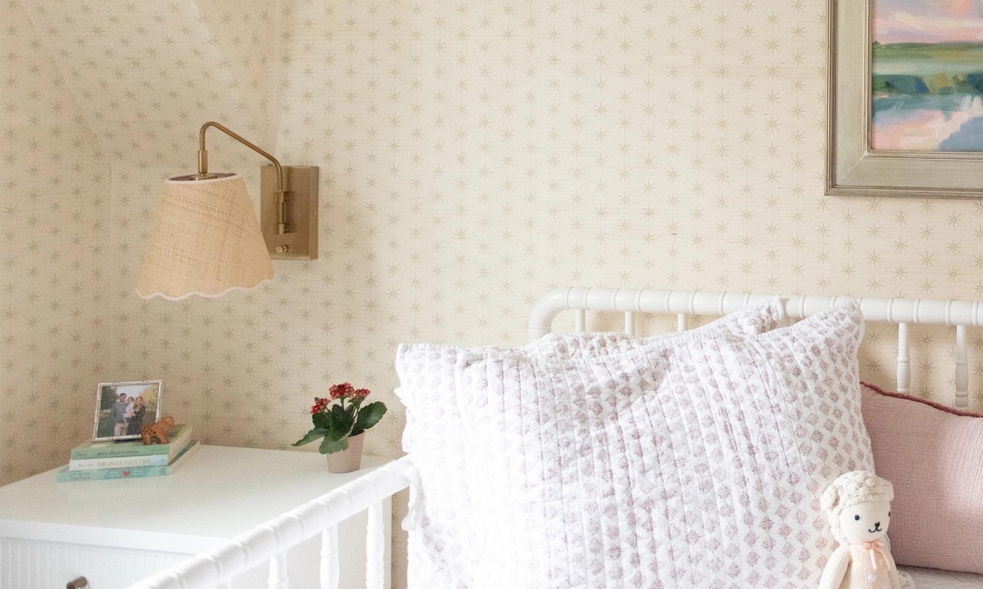 Childs room with neutral star grasscloth wallpaper and classic decor.