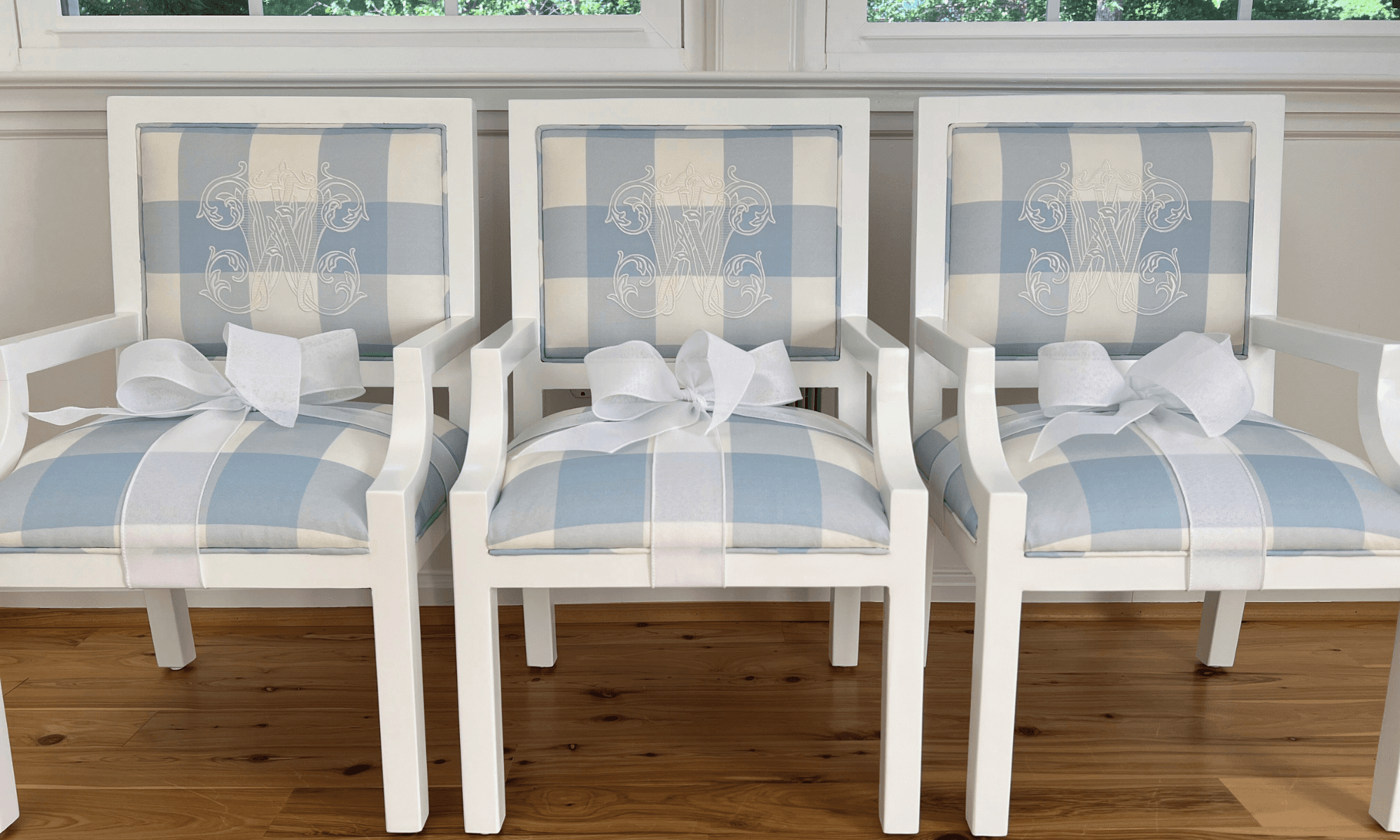 Three blue and white chairs with custom blue plaid upholstery and monogram