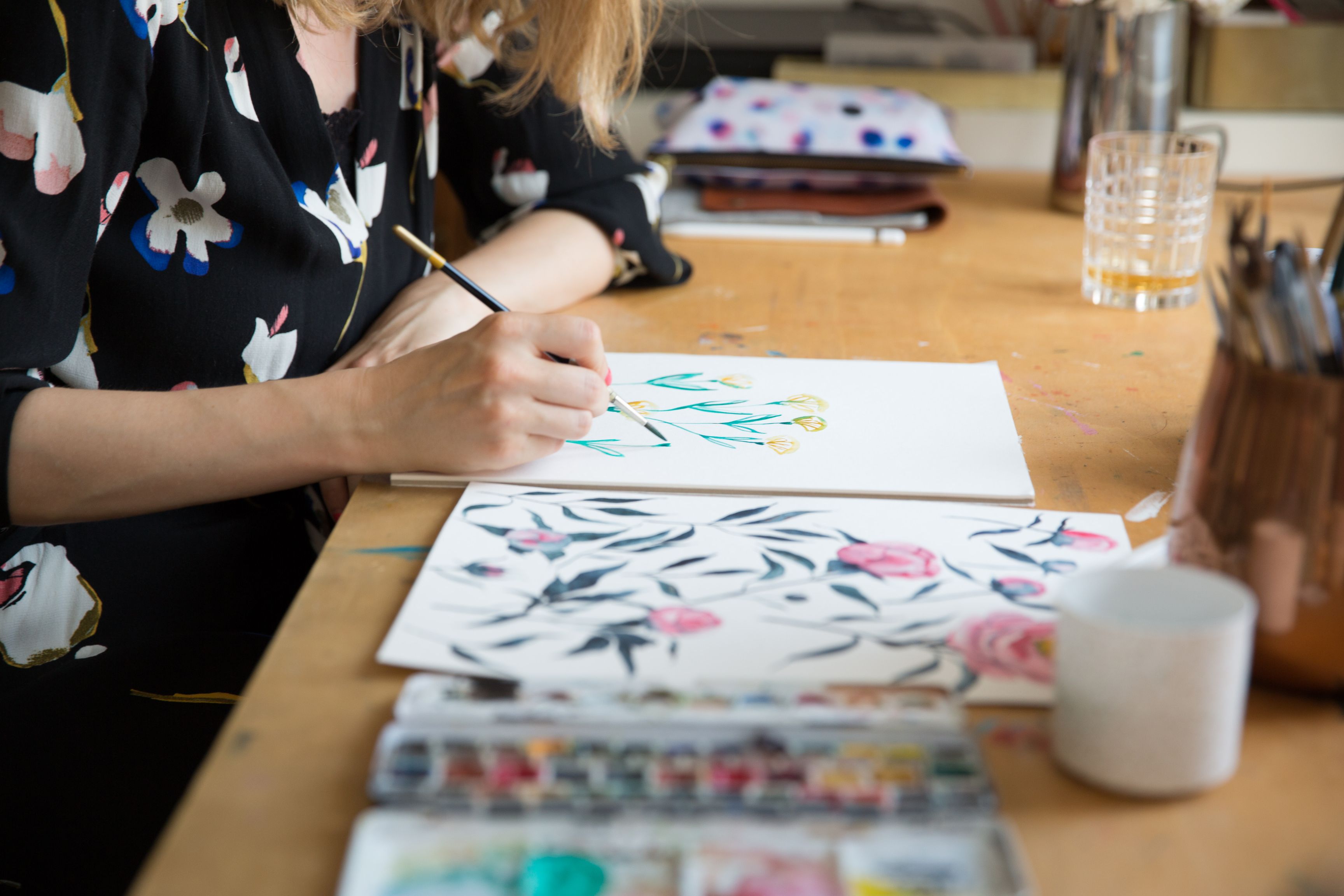 Artist hand painting flowers